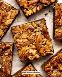 Decadent pecan pie brownies topped with pecans and chocolate drizzle