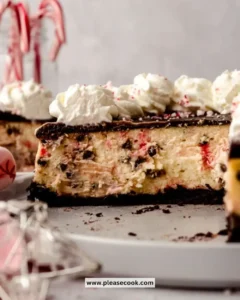 Slice of peppermint bark cheesecake topped with crushed candy canes