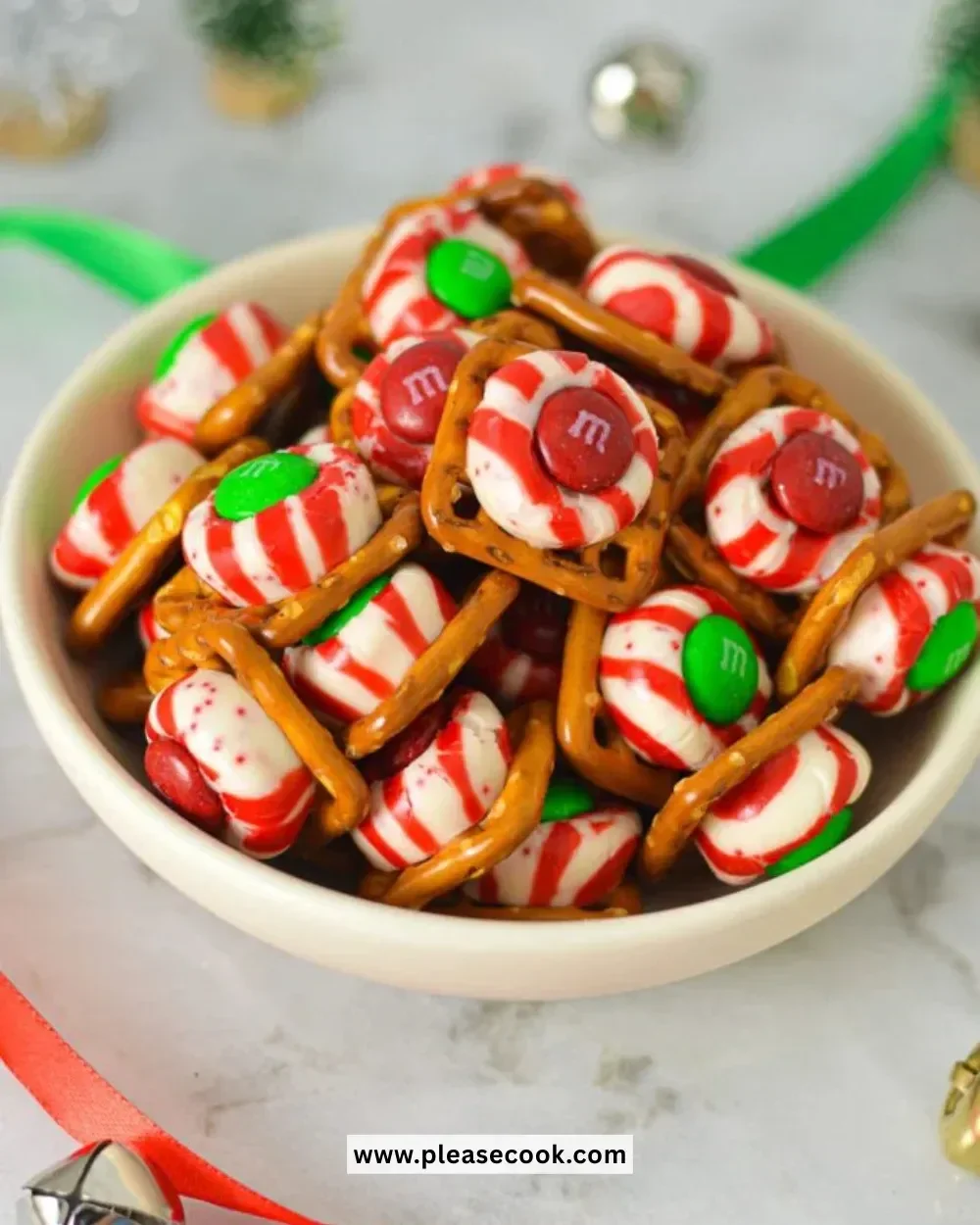 Delicious Peppermint Kiss Pretzels topped with chocolate and festive sprinkles.