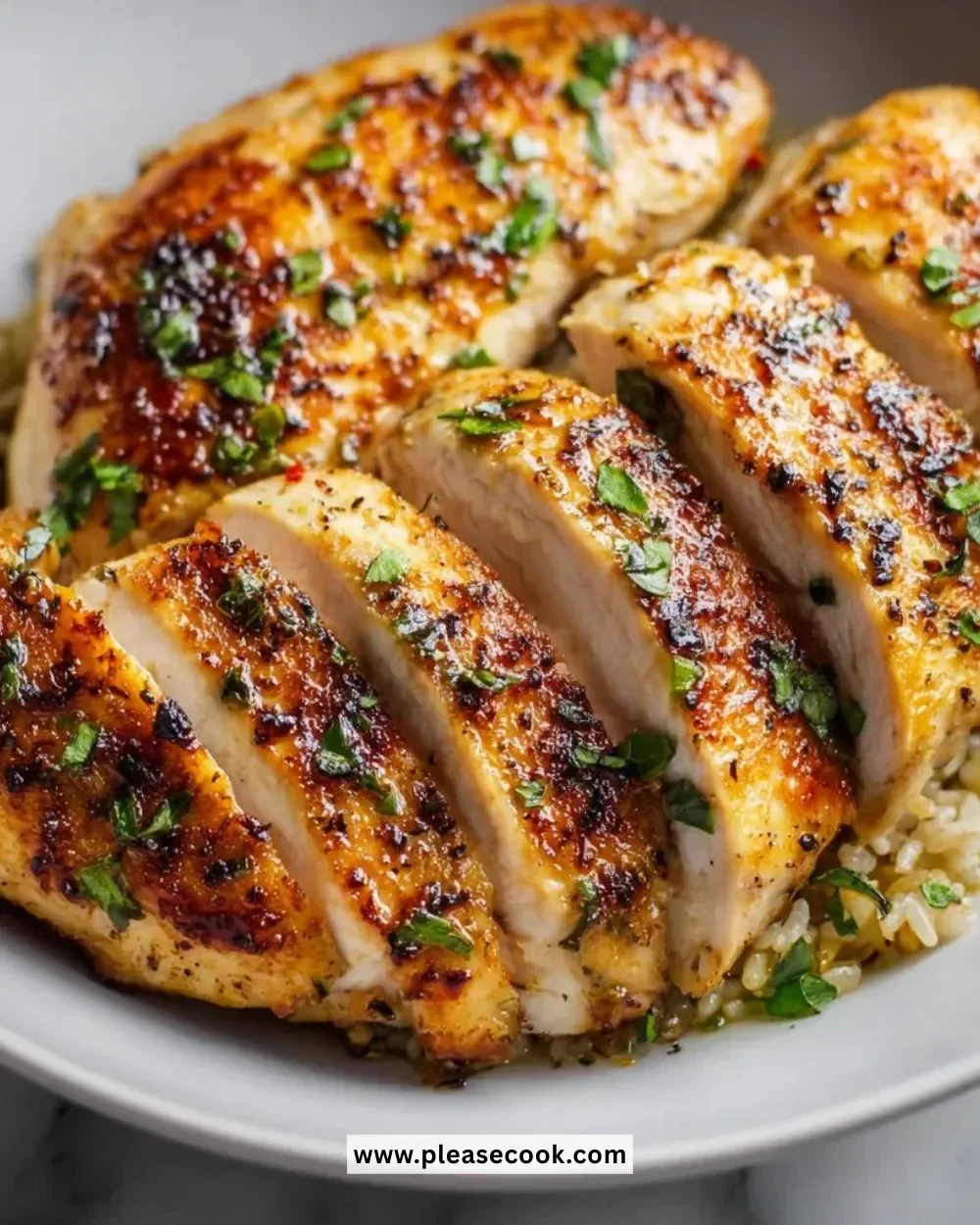 Perfectly juicy pan seared chicken breasts cooked to perfection on a skillet.