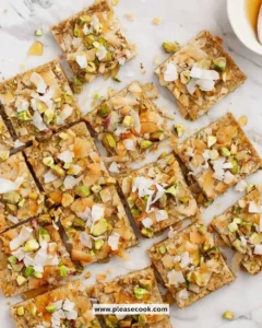Delicious homemade Pistachio Oat Squares on a wooden table