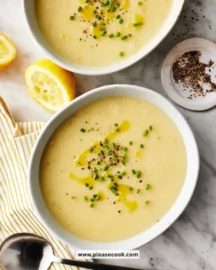 A bowl of creamy Potato Leek Soup garnished with green onions.