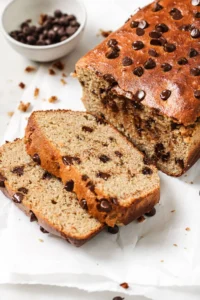 Deliciously moist Protein Banana Bread slice on a wooden board