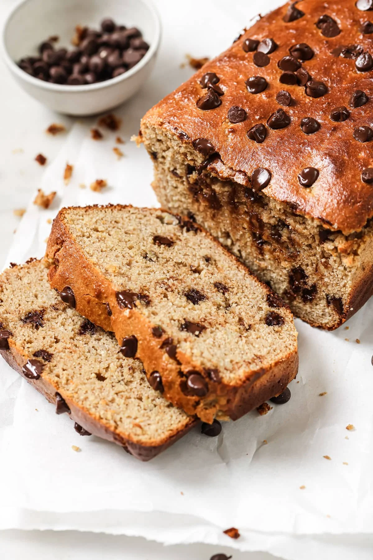 Deliciously moist Protein Banana Bread slice on a wooden board