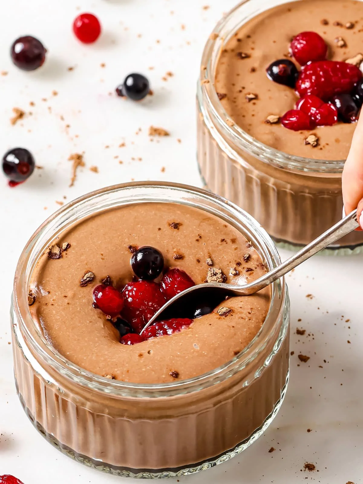 Bowl of creamy chocolate protein pudding topped with fresh berries