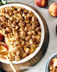 Slice of quick peach cobbler served in a bowl with a scoop of ice cream