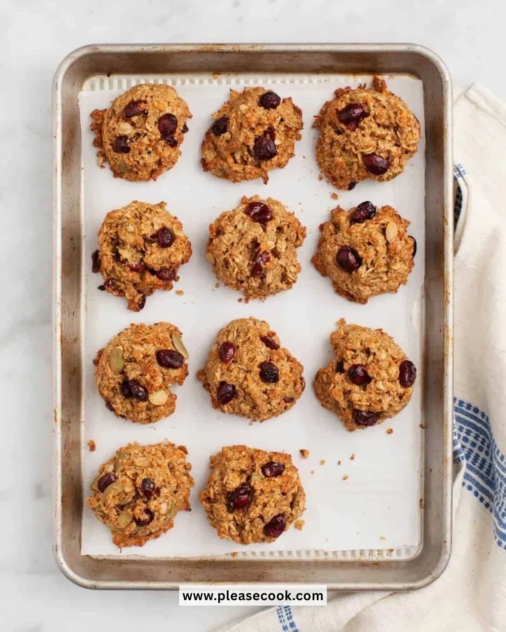 Baked quinoa breakfast cookies with nuts and chocolate chips on a baking tray.