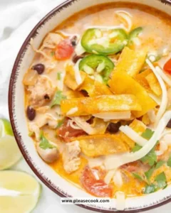 Delicious bowl of slow cooker chicken tortilla soup with toppings.