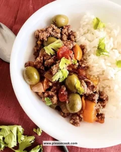 Slow Cooker Cuban Picadillo served with rice and garnish