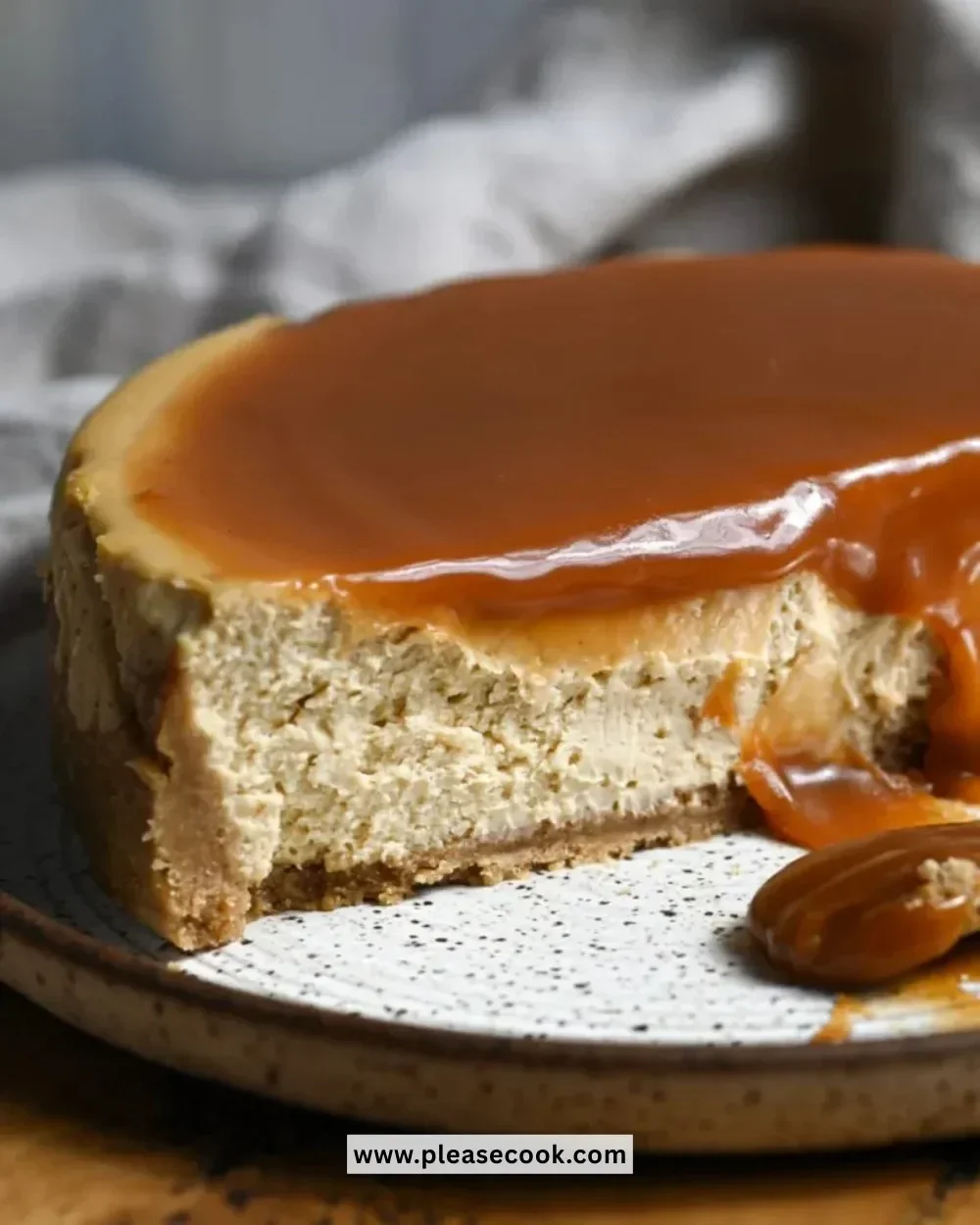 Spiced apple cider cheesecake topped with apple slices and caramel drizzle