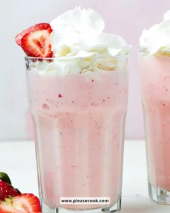 Delicious strawberry milkshake topped with whipped cream and fresh strawberries