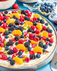 Delicious sugar cookie fruit pizza topped with fresh fruits and creamy frosting