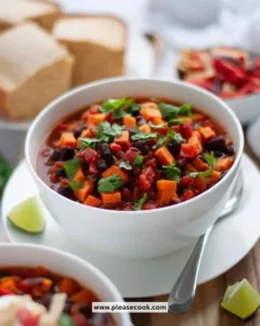 Bowl of Sweet Potato Black Bean Chili topped with avocado and cilantro