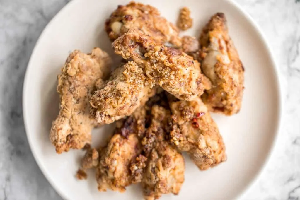 Golden breaded fried chicken wings cooked in an air fryer.