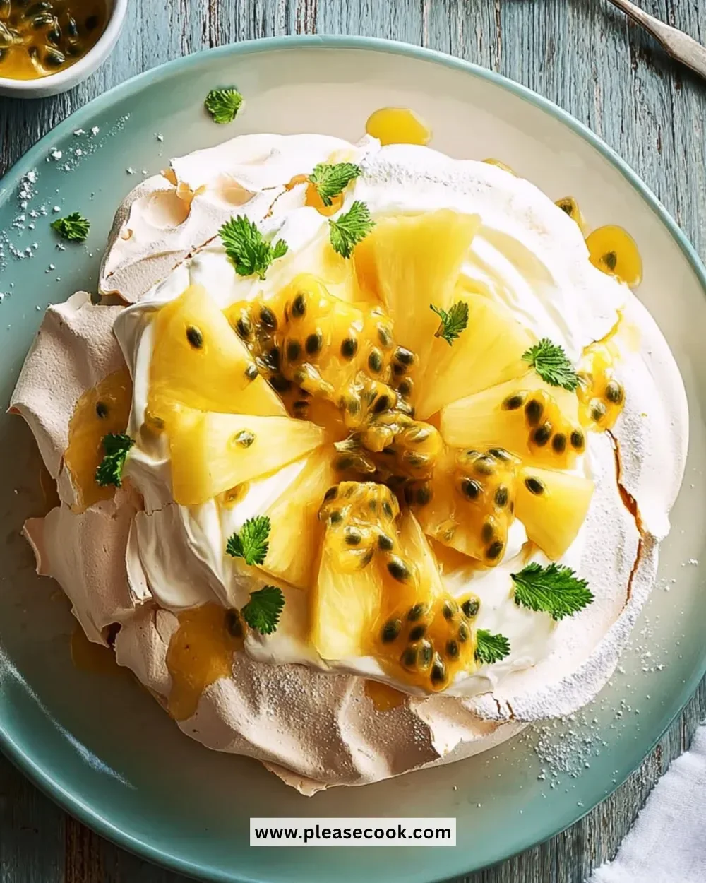 Vanilla Pavlova topped with pineapple and passion fruit, a delicious dessert
