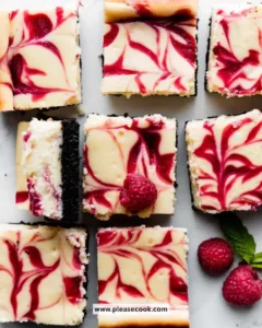 White Chocolate Raspberry Cheesecake Bars with fresh raspberries and chocolate drizzle