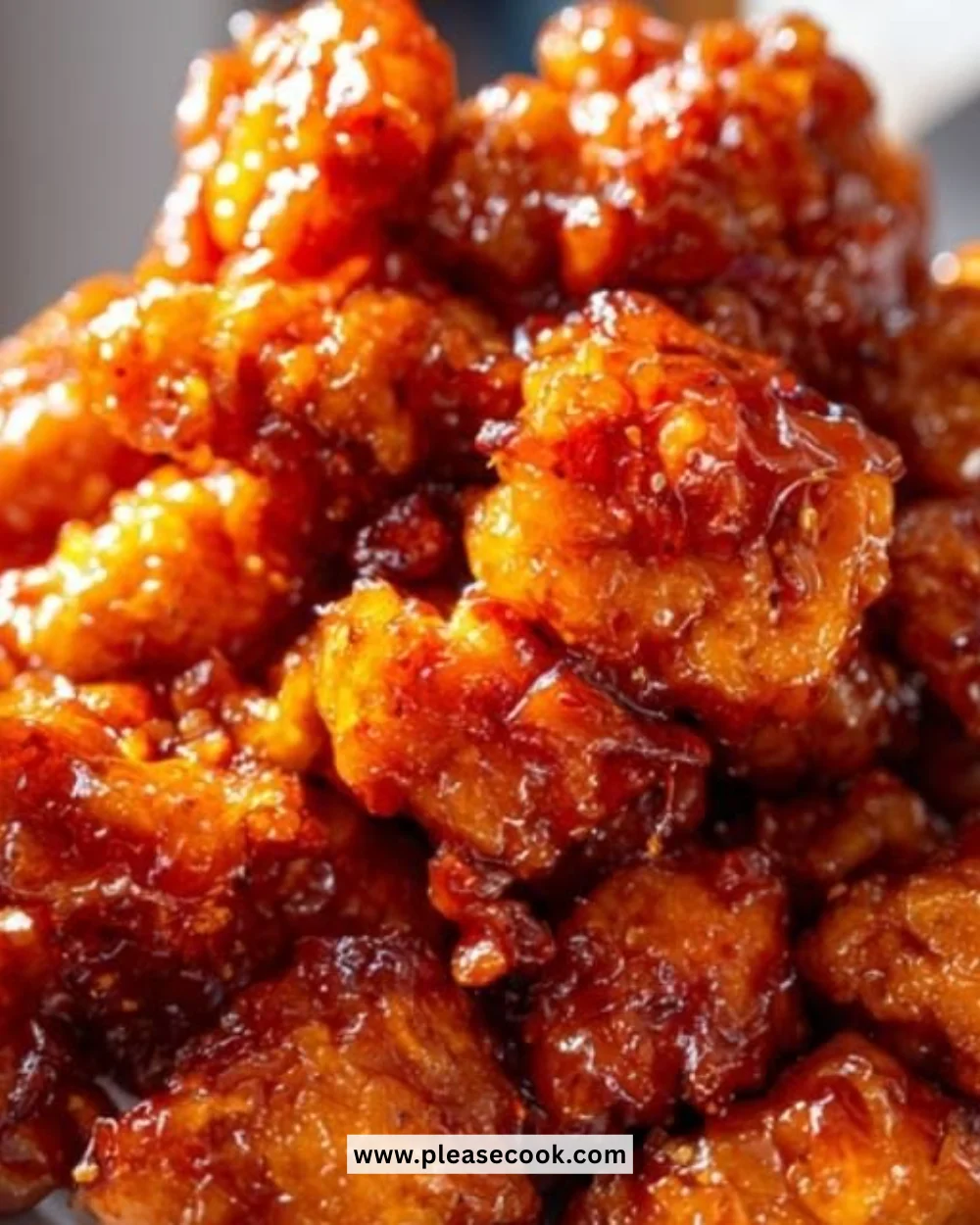 Delicious orange chicken served over rice, garnished with green onions.