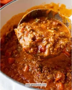 Bowl of authentic Bolognese sauce served with pasta and garnished with herbs