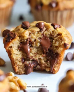 Freshly baked Banana Chocolate Chip Muffins with chocolate chips and bananas
