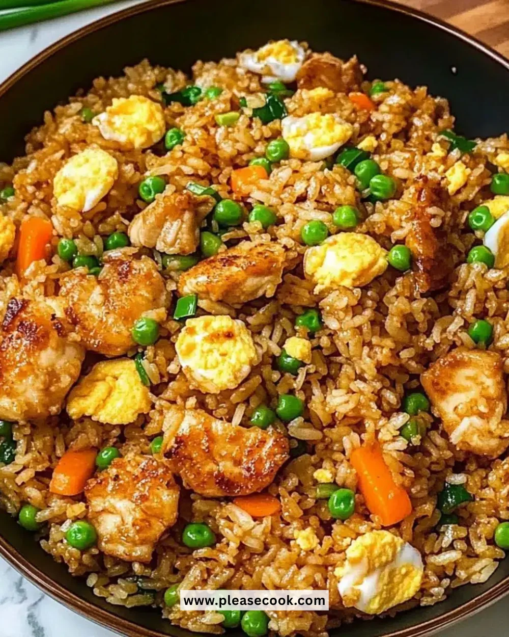 Plate of Bang Bang Fried Rice garnished with vegetables and spices.