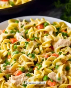 Creamy chicken pot pie noodles served in a bowl with herbs