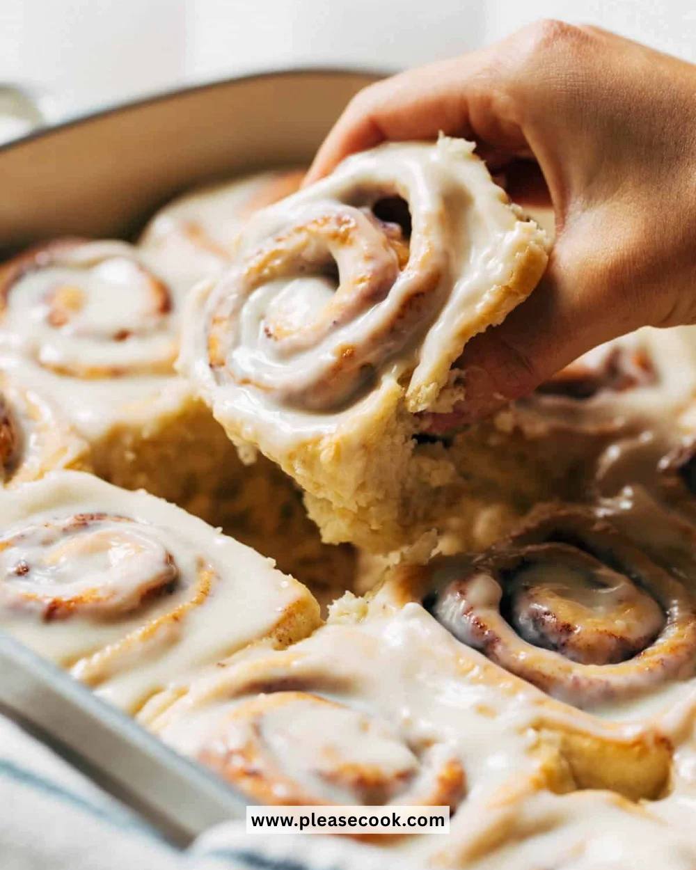 Delicious homemade cinnamon rolls with icing on a wooden table