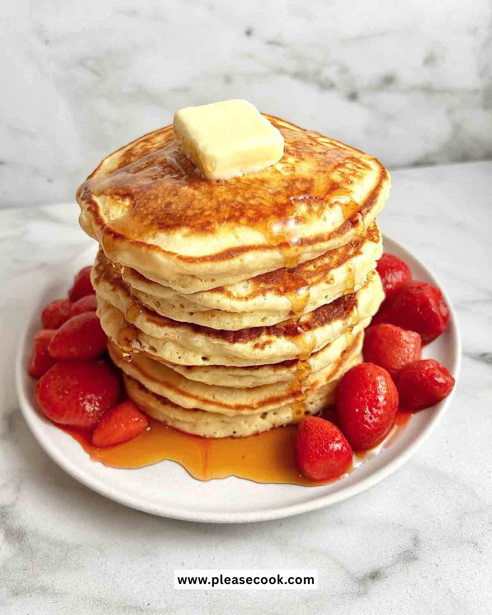Stack of fluffy pancakes drizzled with syrup and topped with fresh berries