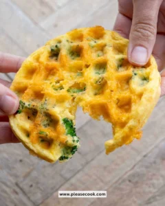 Delicious Broccoli Cheddar Waffles served on a plate with fresh herbs.
