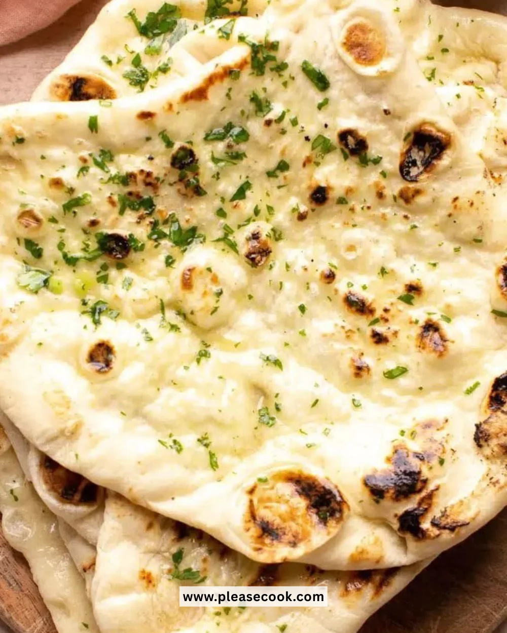 Delicious Butter Naan served with curry on a plate.