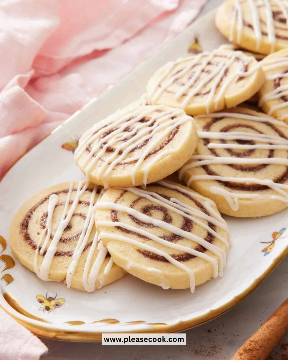 Delicious cinnamon roll cookies topped with icing and cinnamon swirl
