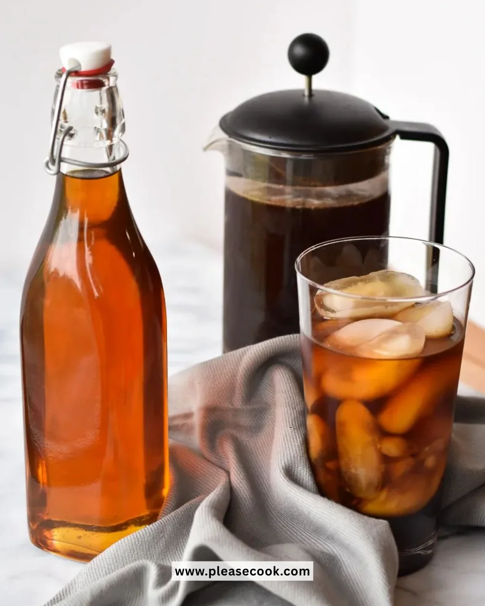 Bottle of coffee syrup with a cup of coffee in the background
