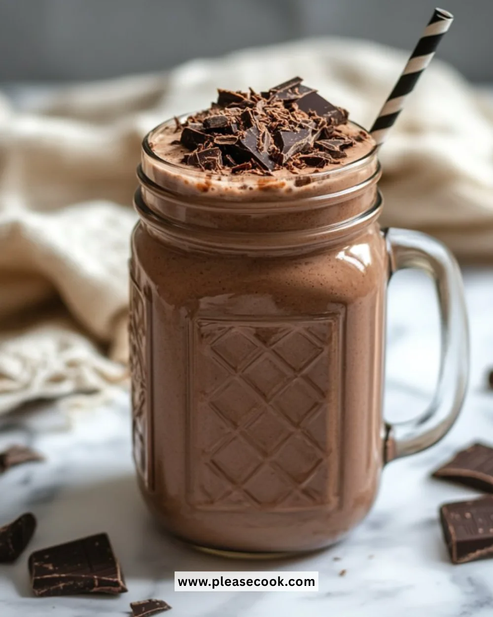Delicious creamy chocolate smoothie in a glass topped with chocolate shavings