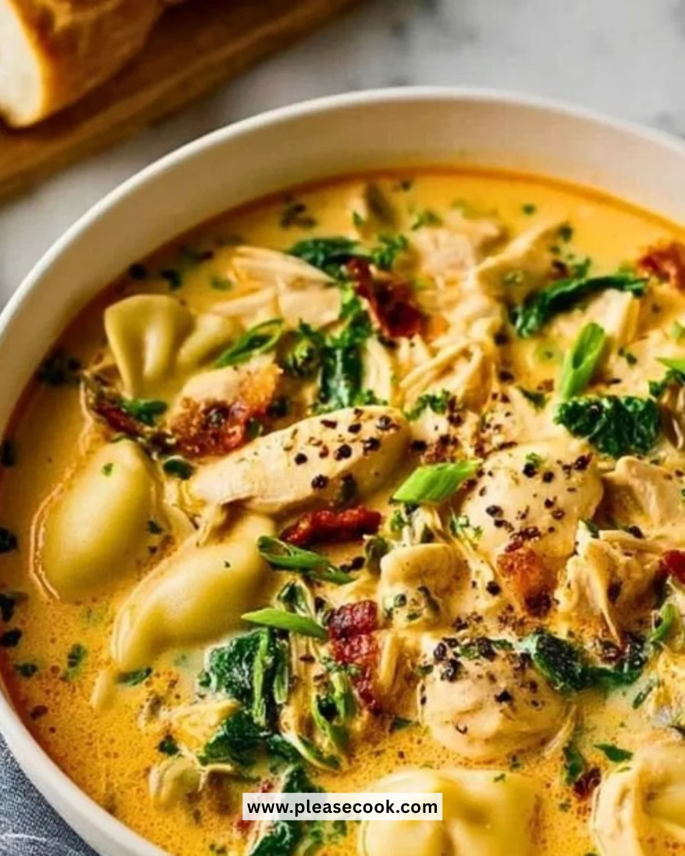 Bowl of creamy Marry Me Chicken soup garnished with herbs.