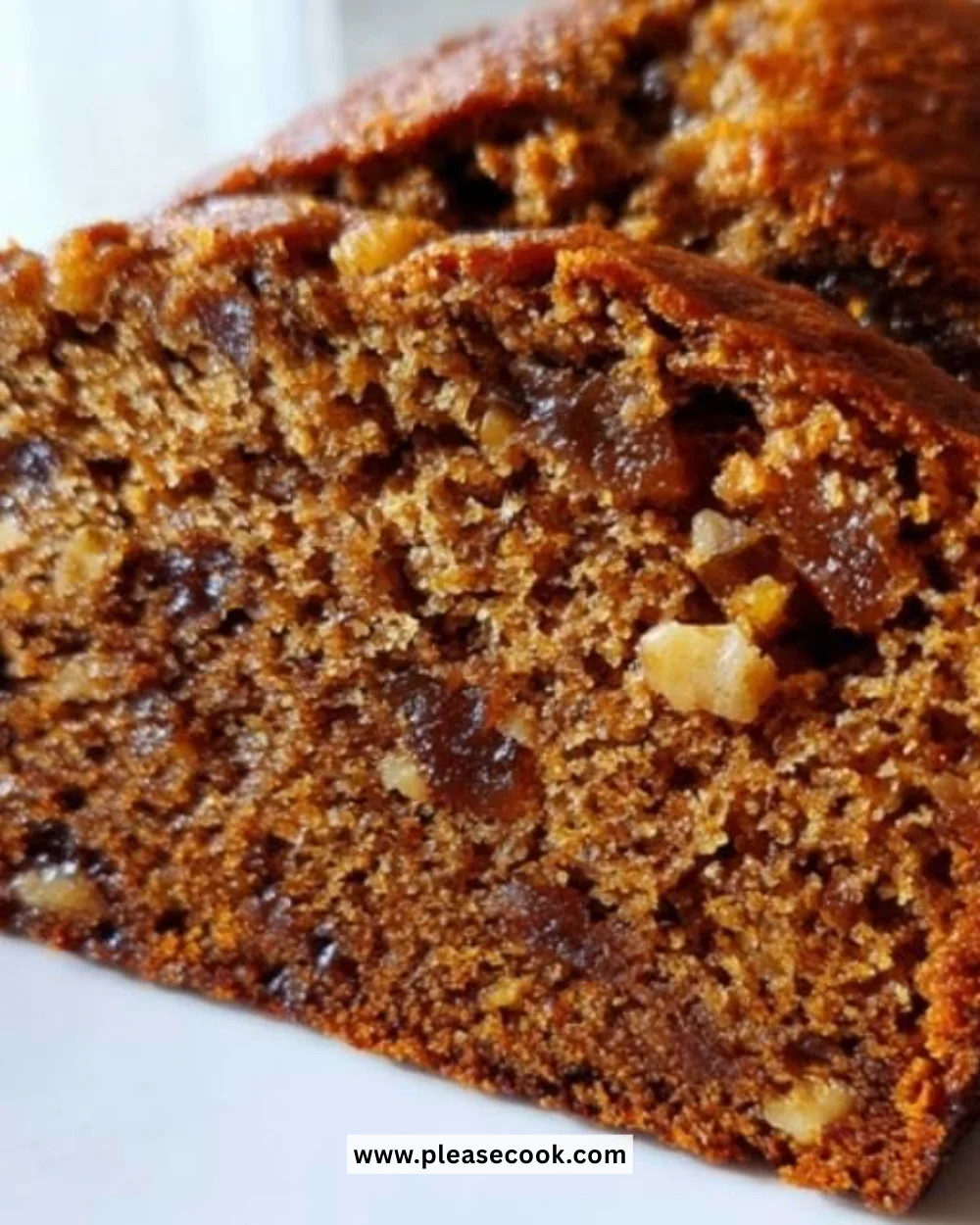 Homemade Date Nut Loaf with nuts and dates on a wooden table