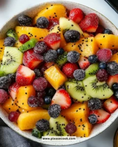 Festive winter fruit salad with fresh seasonal fruits in a bowl