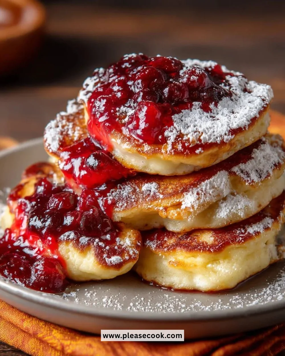 Fluffy homemade pancakes stacked with syrup and fresh fruit