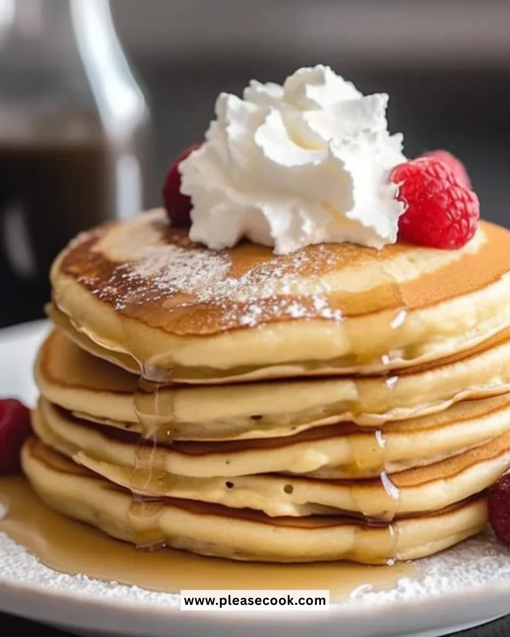 Fluffy low-carb pancakes served on a plate with syrup and berries