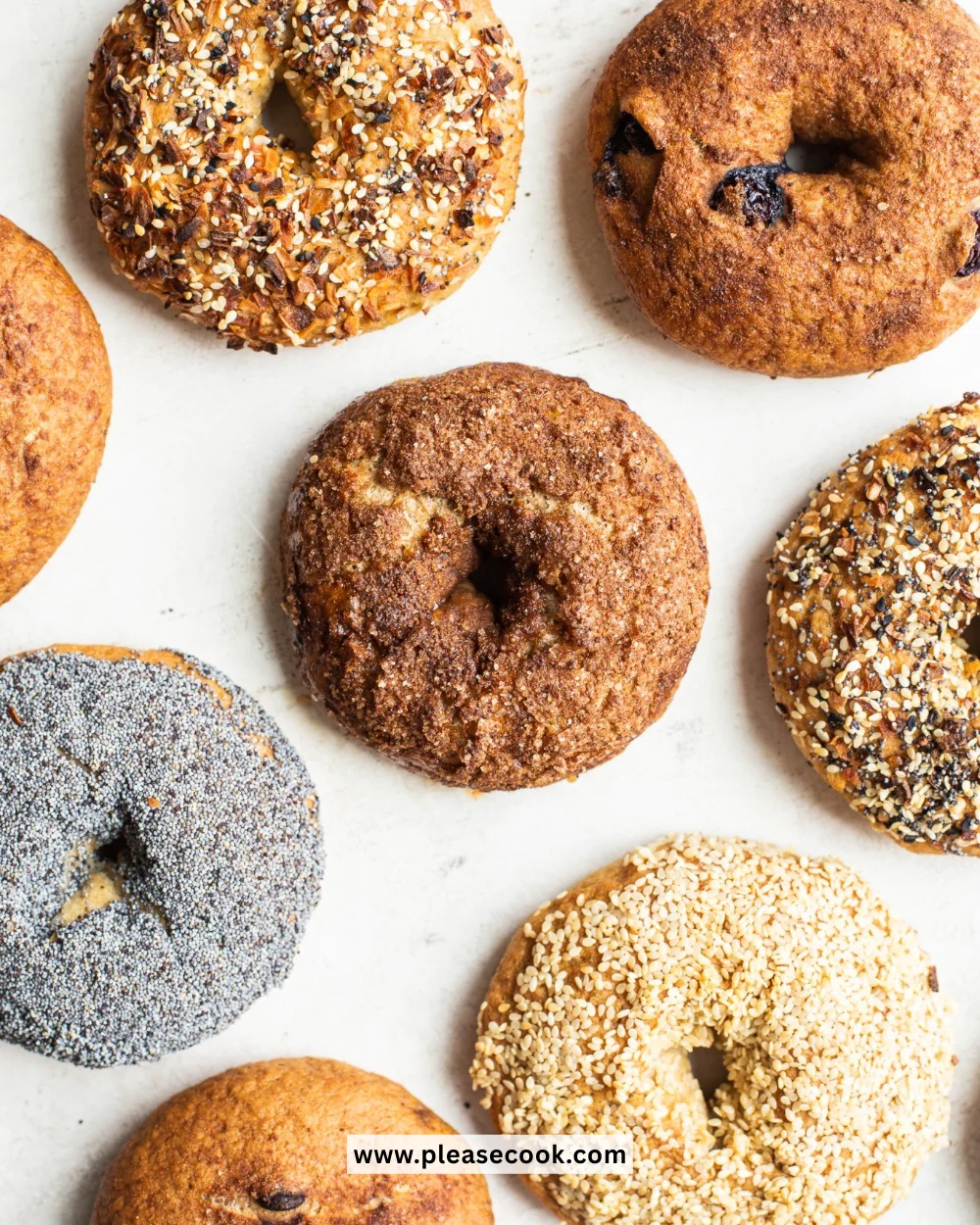 Assorted gluten-free bagels on a wooden table, perfect for breakfast or snacks.