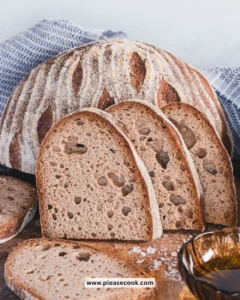 Freshly baked gluten free sourdough bread on a rustic wooden table.
