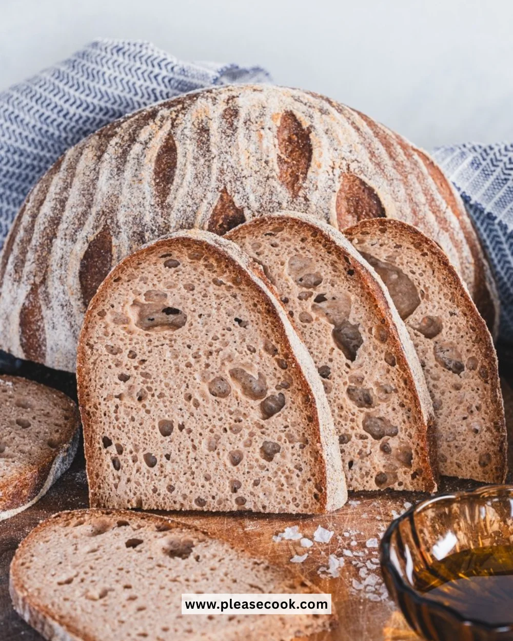 Freshly baked gluten free sourdough bread on a rustic wooden table.