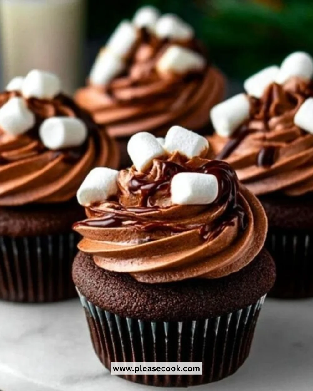 Delicious hot cocoa cupcakes topped with chocolate frosting and marshmallows
