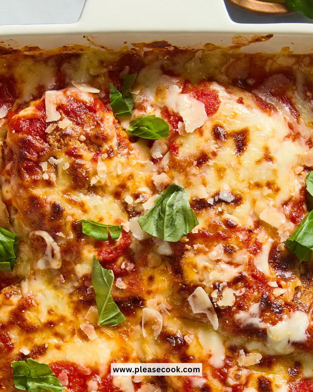 Delicious Keto Chicken Parmesan topped with cheese and herbs