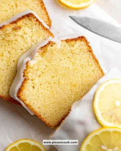 Delicious lemon loaf cake topped with glaze on a white plate