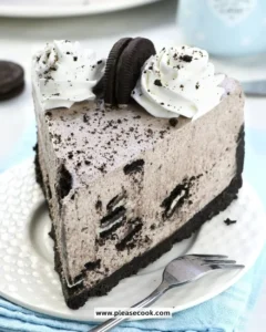 No Bake Oreo Cheesecake topped with Oreo cookies on a white plate