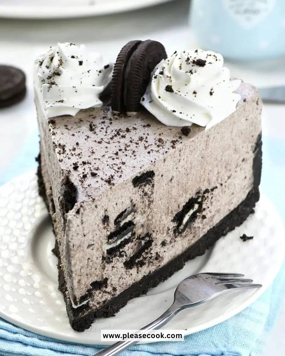 No Bake Oreo Cheesecake topped with Oreo cookies on a white plate