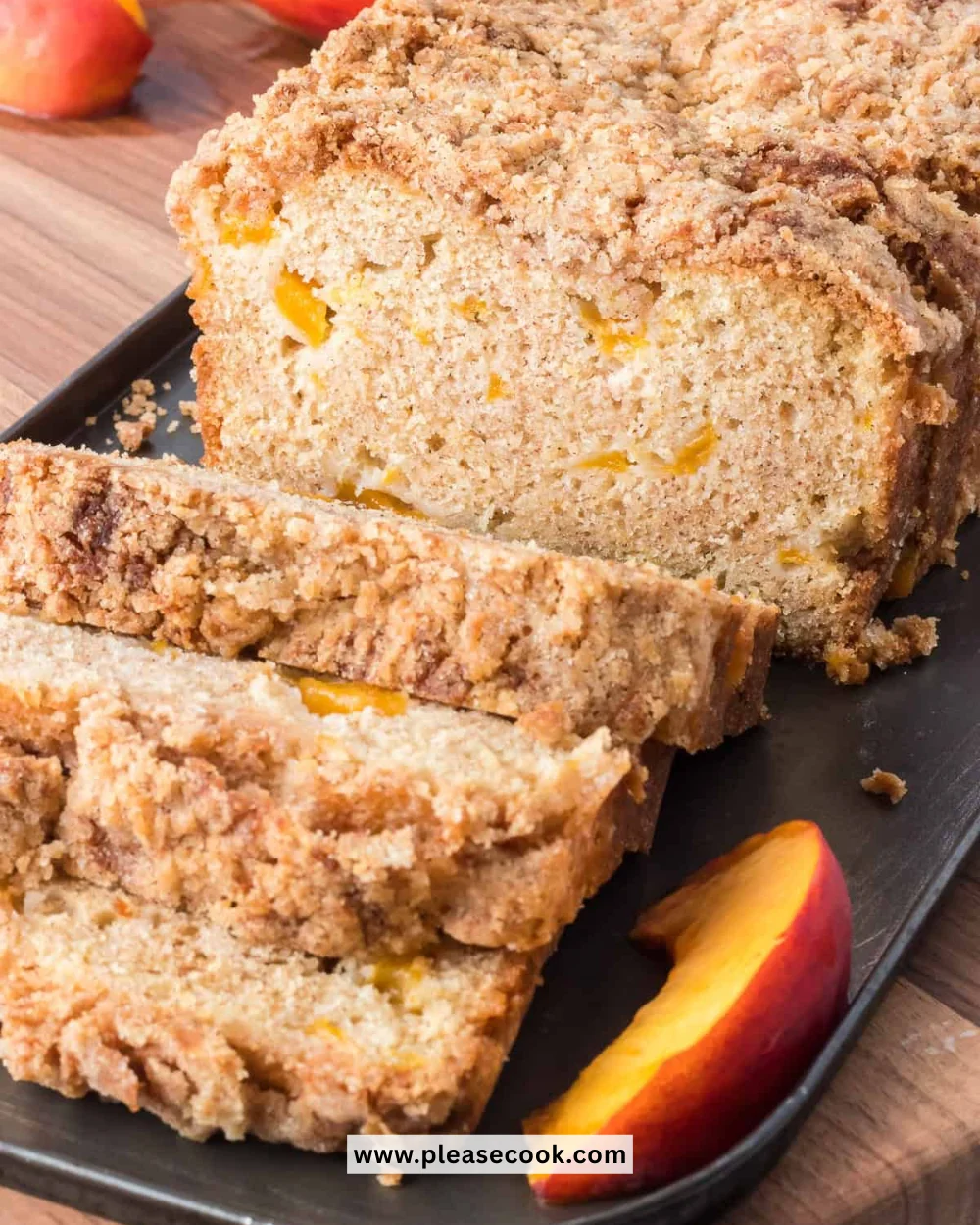 Homemade peach bread with chunks of fresh peaches on a wooden table.