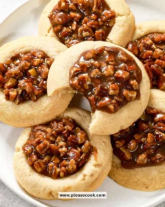 Plate of freshly baked Pecan Pie Cookies with pecans and caramel glaze