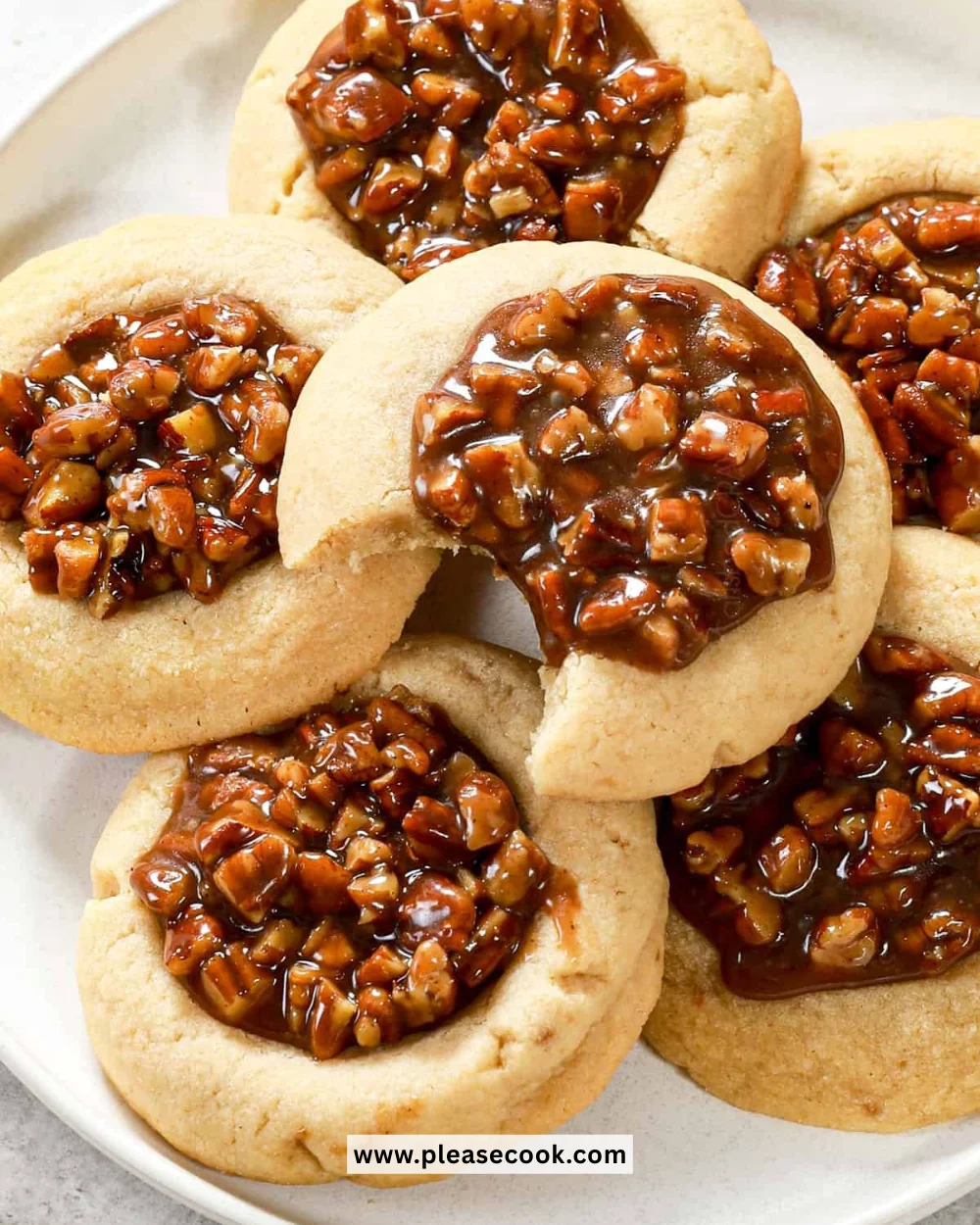 Plate of freshly baked Pecan Pie Cookies with pecans and caramel glaze