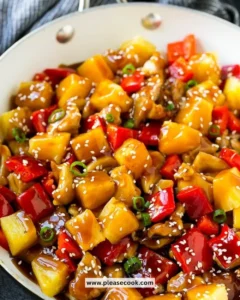 Delicious Pineapple Chicken served on a plate with vibrant vegetables.