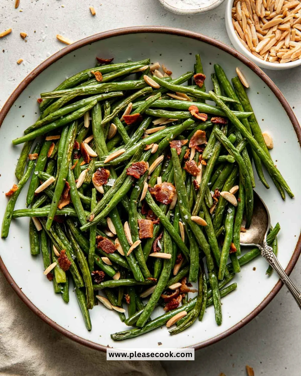 Plate of perfectly roasted green beans garnished with herbs